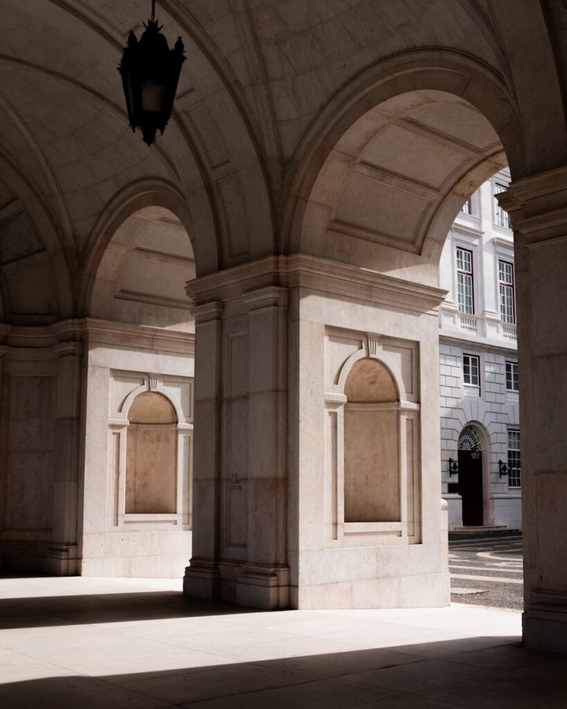 Arches and columns in a sunlit building interior
